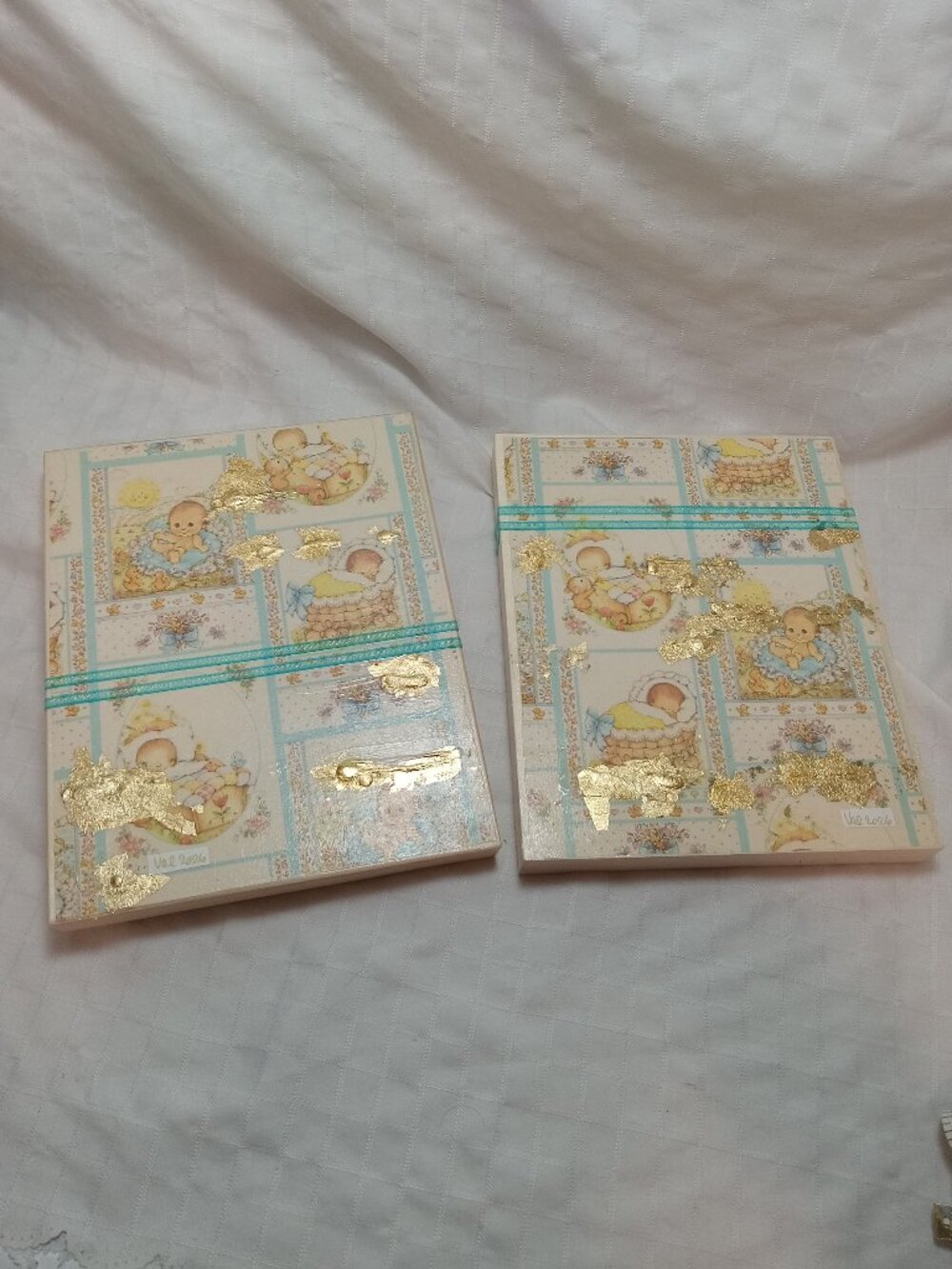 A set of delicate wooden frames for a baby's room with vintage wrapping paper